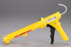 A dripless plastic caulking gun that is yellow in color and holds sealant and caulk for applying to surfaces.