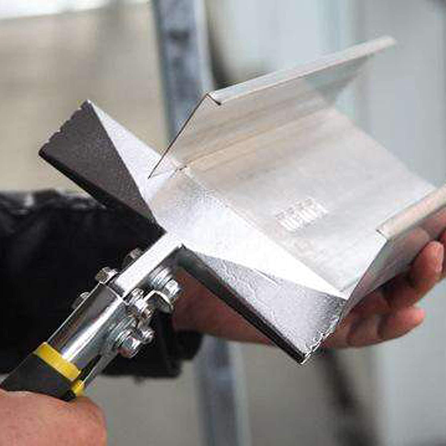 A piece of sheet metal being bent at an angle with the 6 inch wide sheet metal hand benders.